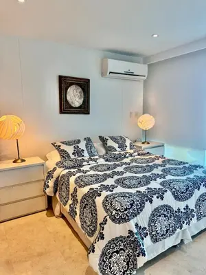 a bedroom with a bed and a clock on the wall at Beautiful 2 BR Ocean View Condo in Cartagena in Cartagena de Indias
