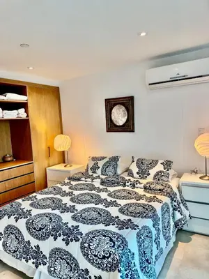 a bedroom with a bed and a clock on the wall at Beautiful 2 BR Ocean View Condo in Cartagena in Cartagena de Indias