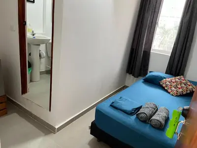 a small bed in a room with a mirror at Habitación cerca de la playa 201 in Cartagena de Indias