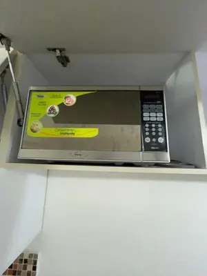 a microwave oven sitting on top of a shelf at Alessandro estilo italiano in Cartagena de Indias