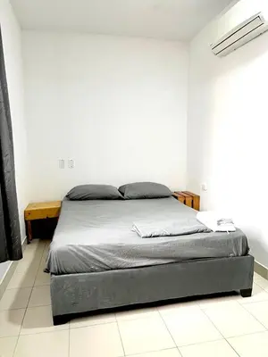 a bedroom with a bed in a white room at Habitación cerca de la playa 202 in Cartagena de Indias