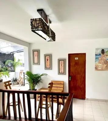a dining room with a table and a red door at Habitación cerca de la playa 202 in Cartagena de Indias
