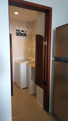 a small kitchen with a refrigerator and a counter at Tropical Paradise - vista al mar, el Laguito Cartagena in Cartagena de Indias