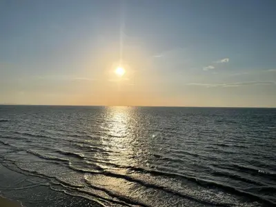 a view of the ocean with the sun in the sky at Eco Hotel Laguna Beach - Bloque 8 Suite 101 in San Silvestre