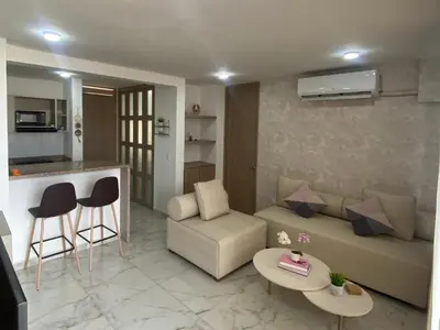 a living room with a couch and a table at Apartamento en el Norte de Barranquilla in Barranquilla
