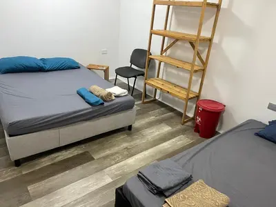 a bedroom with two beds and a ladder and a chair at Habitación cerca de la playa 103 in Cartagena de Indias