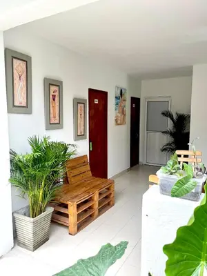 a living room with a wooden bench and plants at Habitación cerca de la playa 103 in Cartagena de Indias