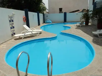 a row of blue swimming pools with chairs around them at Apartamento en Bello Horizonte, Santa Marta in Santa Marta