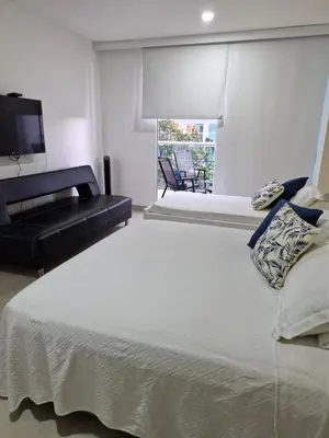 a bedroom with a large bed and a television at Apartamento con vista al Mar Cartagena Morros 3 in Cartagena de Indias