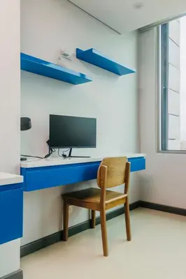 a chair sitting at a desk with a television at Apartment Hilton Garden Inn Building in Barranquilla
