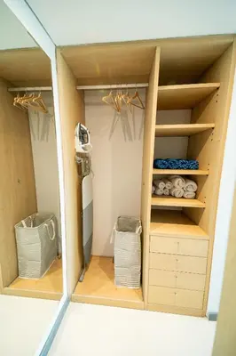 a walk in closet with wooden shelves at Apartment Hilton Garden Inn Building in Barranquilla