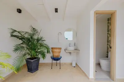a bathroom with a sink and a potted plant at Lux Beach House, Aldaba Selection in Cartagena de Indias