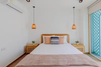 a bedroom with a bed and a window at Lux Beach House, Aldaba Selection in Cartagena de Indias