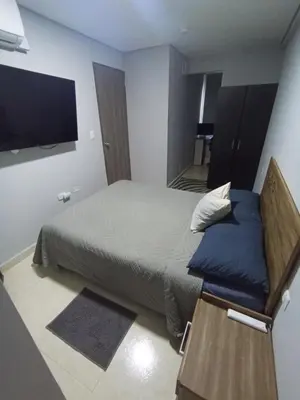 a bedroom with a bed and a flat screen tv at Amaneceres de ensueño en Cartagena in Cartagena de Indias