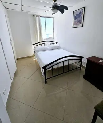 a bedroom with a bed and a ceiling fan at Vacation Home with water views in every room! in Cartagena de Indias