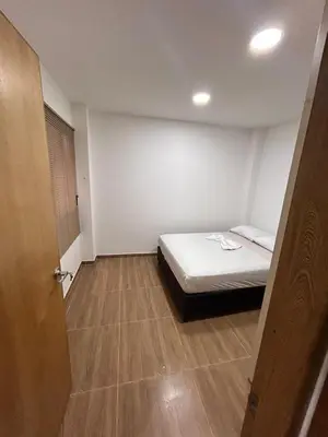 a small bedroom with a bed and a wooden floor at Apartamento Villa Mary C-202 in Coveñas