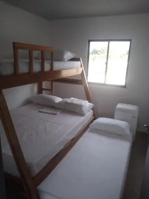 two bunk beds in a room with a window at Casa de playa moñitos in Moñitos