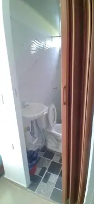 a bathroom with a white toilet and a sink at Casa de playa moñitos in Moñitos