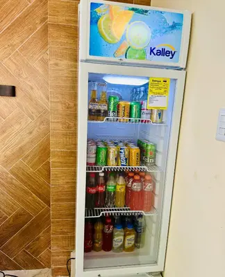 a refrigerator filled with soda and sodas at Glamping Arena in El Porvenir