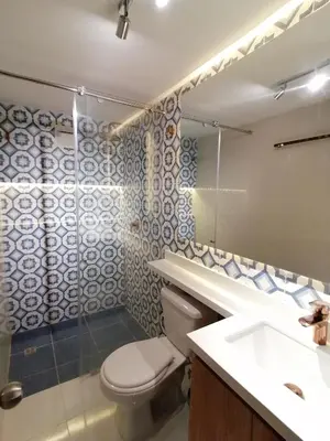 a bathroom with a toilet and a sink and a mirror at Apartamento Rosedale in Cartagena de Indias