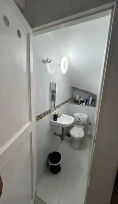 a white bathroom with a sink and a toilet at Casa Étoile ideal location Ctg in Cartagena de Indias