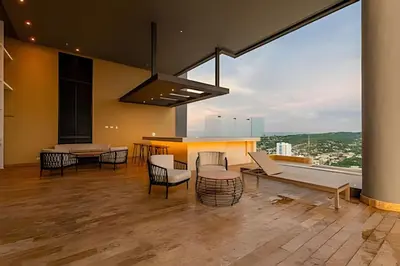 a living room with a table and chairs and a large window at Lujoso y Nuevo Cerca al Centro/ Piscina Panorámica in Cartagena de Indias