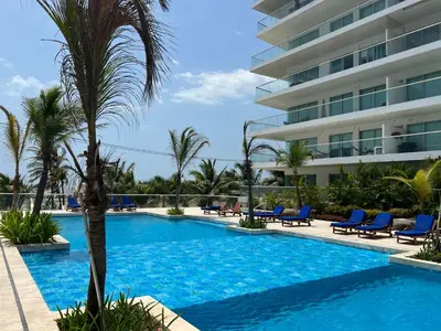a swimming pool in front of a building at Espectacular apto frente al Mar! in Cartagena de Indias