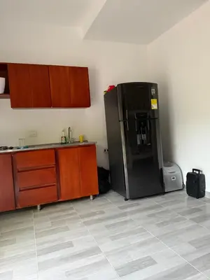 a kitchen with a black refrigerator in the corner at Playa y selva in Puerto Viejo