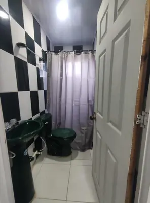 a bathroom with a green toilet and a sink at Apartamento #1 in Puerto Colombia