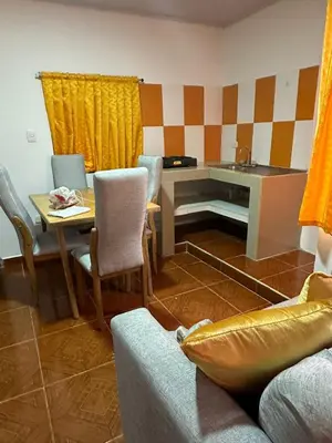 a living room with a desk and a table and chairs at Apartamento #1 in Puerto Colombia