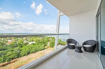 a room with two chairs and a large window at Beach 2-bedroom apartment in Cartagena de Indias