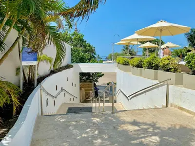 a staircase leading up to a building with an umbrella at Beach 2-bedroom apartment in Cartagena de Indias