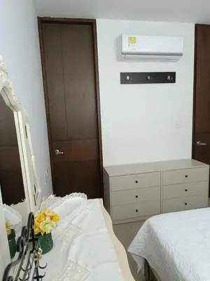 a bedroom with a bed and a dresser and a mirror at Edificio Mares de Coveñas apto frente al Mares de coveñas in Coveñas