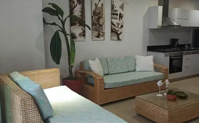 a living room with a couch and a chair at Edificio Mares de Coveñas apto frente al Mares de coveñas in Coveñas