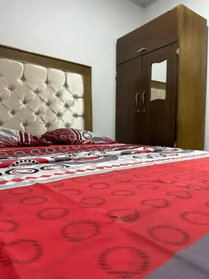 a bedroom with a bed with a red blanket and a mirror at Apartamento #2 in Puerto Colombia