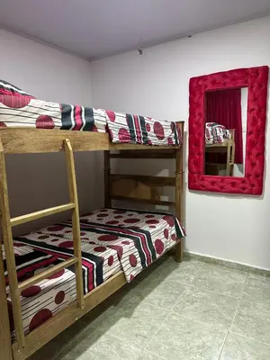 a bedroom with two bunk beds and a mirror at Apartamento #2 in Puerto Colombia