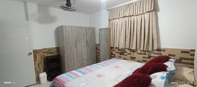a bedroom with a bed and a dresser in it at Apartamento #3 in Puerto Colombia