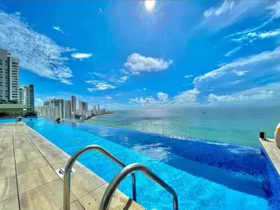 a swimming pool with a view of the ocean at Luxury apt sea front AC Wifi pool at cartagena in Cartagena de Indias