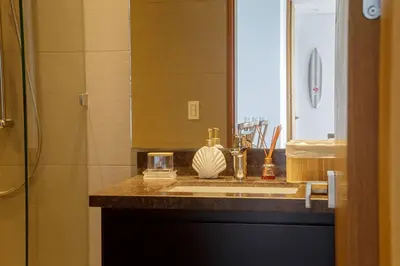 a bathroom with a sink with a mirror and a shower at Luxury apt sea front AC Wifi pool at cartagena in Cartagena de Indias