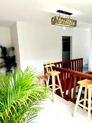 a balcony with wooden stools and a potted plant at Habitación cerca de la playa 204 in Cartagena de Indias