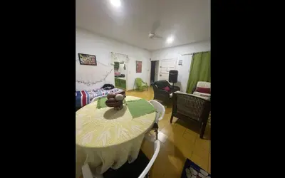 a living room with a table and a room with a couch at Cabaña Mery frente al mar in San Antero