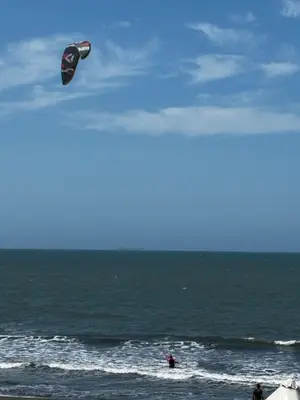 a person flying a kite over the ocean at casa kite school in Cartagena de Indias