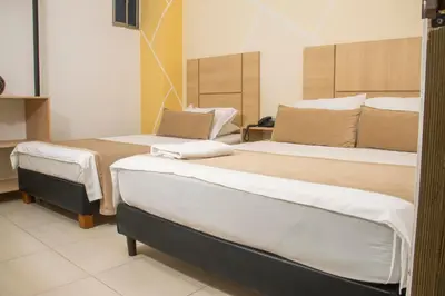 a bedroom with two beds in a room at Hotel Central in Sincelejo