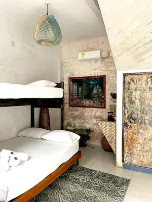 a bedroom with two bunk beds and a rug at Pachamama Hostel in Cartagena de Indias