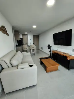 a living room with a white couch and a flat screen tv at Hermoso apartamento in Cartagena de Indias