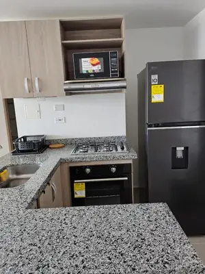 a kitchen with a stove and a microwave at Hermoso apartamento in Cartagena de Indias