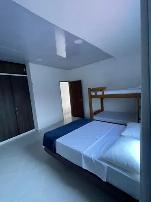 a bedroom with a bed in a white room at Apartamento Salome Coveñas in Coveñas