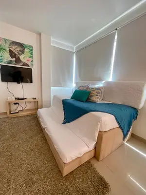 a bedroom with a bed and a tv in it at Apartamentos cerca al hotel Las Americas in Cartagena de Indias