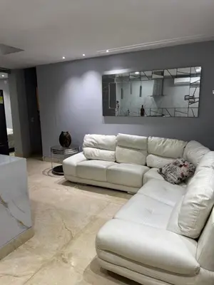 a living room with a white couch and a table at Apartamento 2 habitaciones zona Riomar Barranquilla in Barranquilla