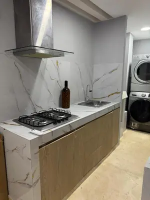 a kitchen with a stove and a sink and a washing machine at Apartamento 2 habitaciones zona Riomar Barranquilla in Barranquilla